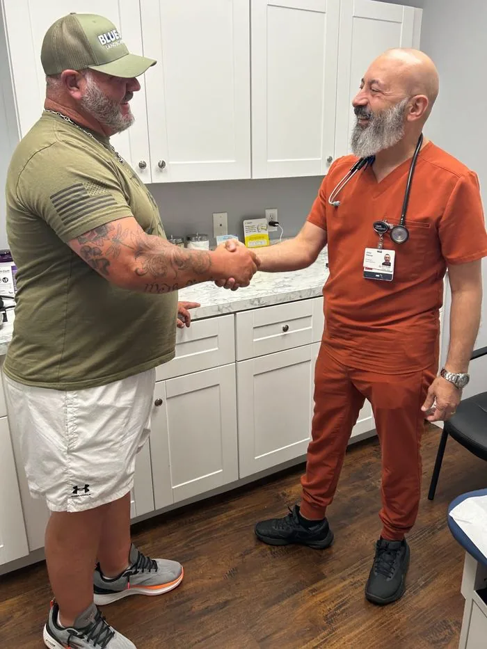 Dr. John Hanna greeting a patient in the exam room