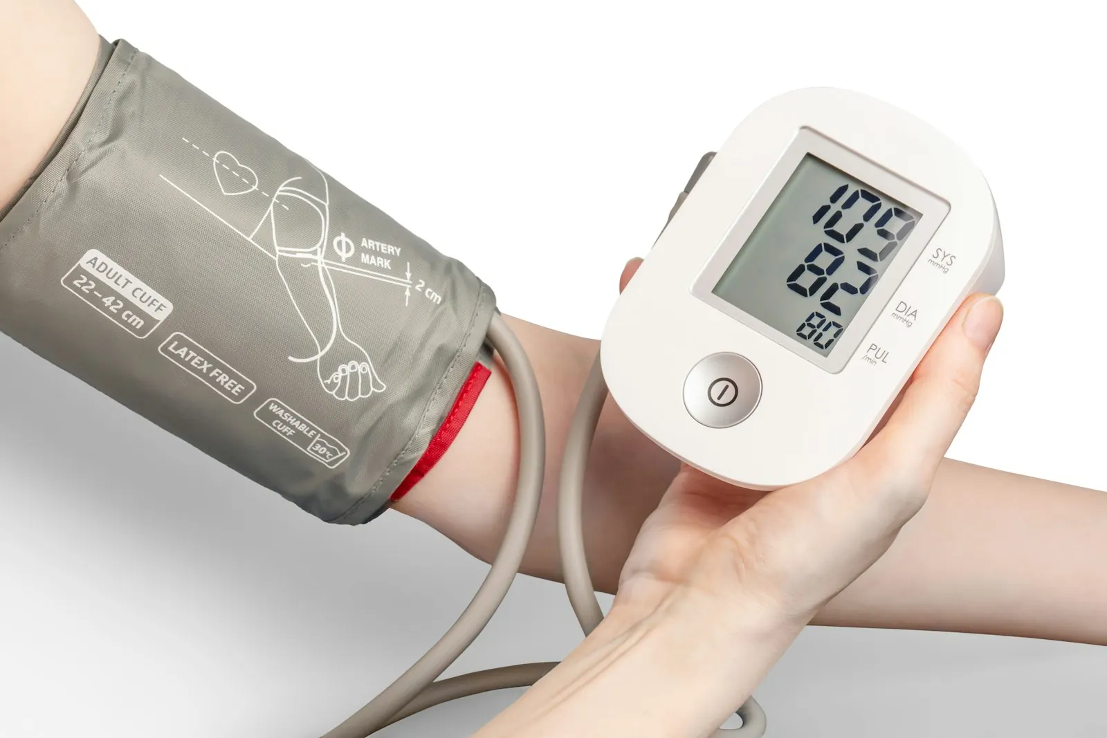 An upper arm blood pressure cuff connected to a digital home monitor