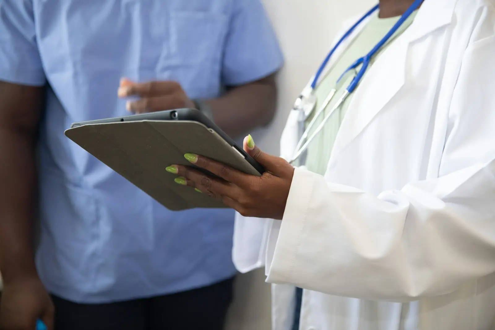 A patient asking questions at a clinic front desk